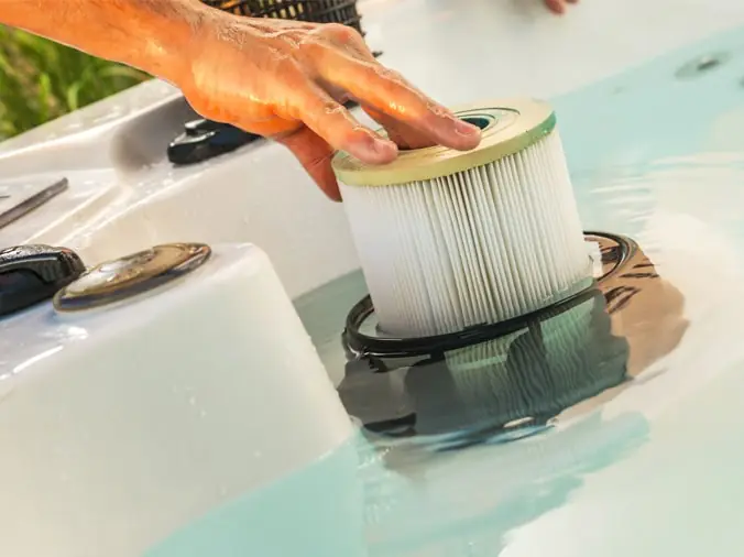 Person replacing a pool filter